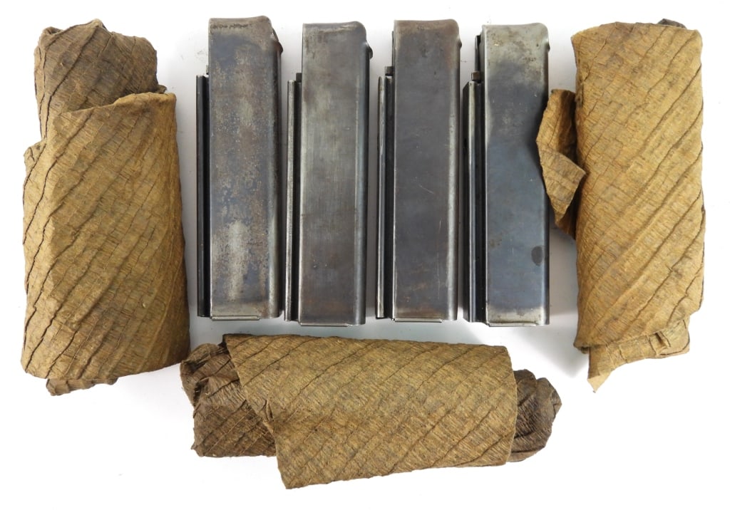 Seven Patent Date Thompson SMG Magazines: Seven patent date Thompson SMG magazines in a paper wrapping marked "PATENTED-AUG. 24, 1920/AUG 24, 1920.-JAN. 11, 1921".Disclaimer and lot information: Many states restrict or prohibit magazines