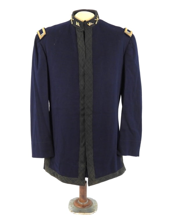 Virginia Model 1895 Undress 1st Lieutenant's Tunic: Dark blue broadcloth tunic body, green worsted tape along the front, collar, and skirt, brass "VA" and crossed rifle insignia with a "I", 1st lieutenant's shoulder boards, and a black lining.
