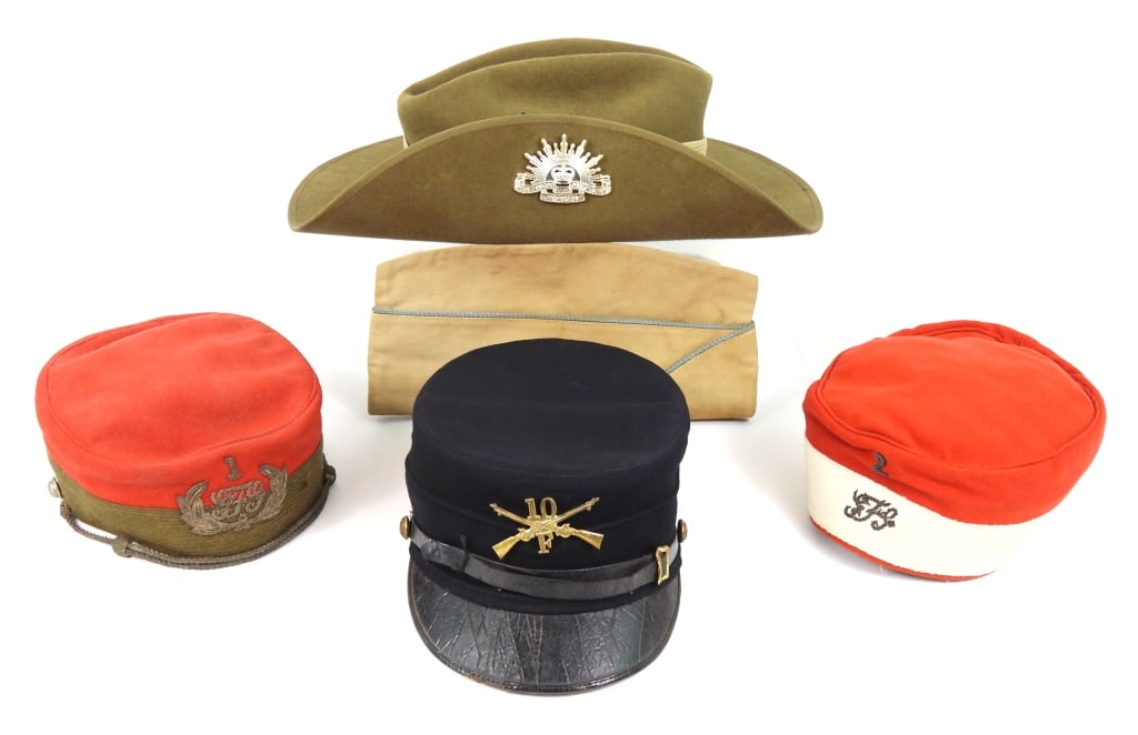 Group of Military Headgear: An Australian fur felt hat dated 1974; two pillbox-style caps; a khaki overseas cap with blue piping; and an Ohio National Guard cap with crossed rifles and "10/F" insignia on the front, cuff-size