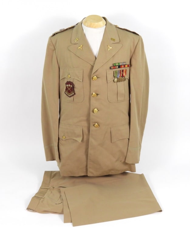 US Army Medical Officers Uniform: A khaki wool twill woven summer tunic with brass buttons, an embroidered United States Army Medical Department Center patch on the right breast pocket, US and medical insignia on the collar and
