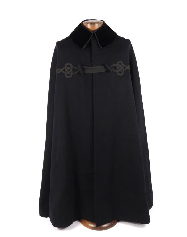 US Navy Boat Cloak: Dark blue wool boat cloak with a rolling collar of dark blue velvet with a double hook and eye closure, a set of mohair frogs with loops and toggles secure the front of the cloak, black silk lining