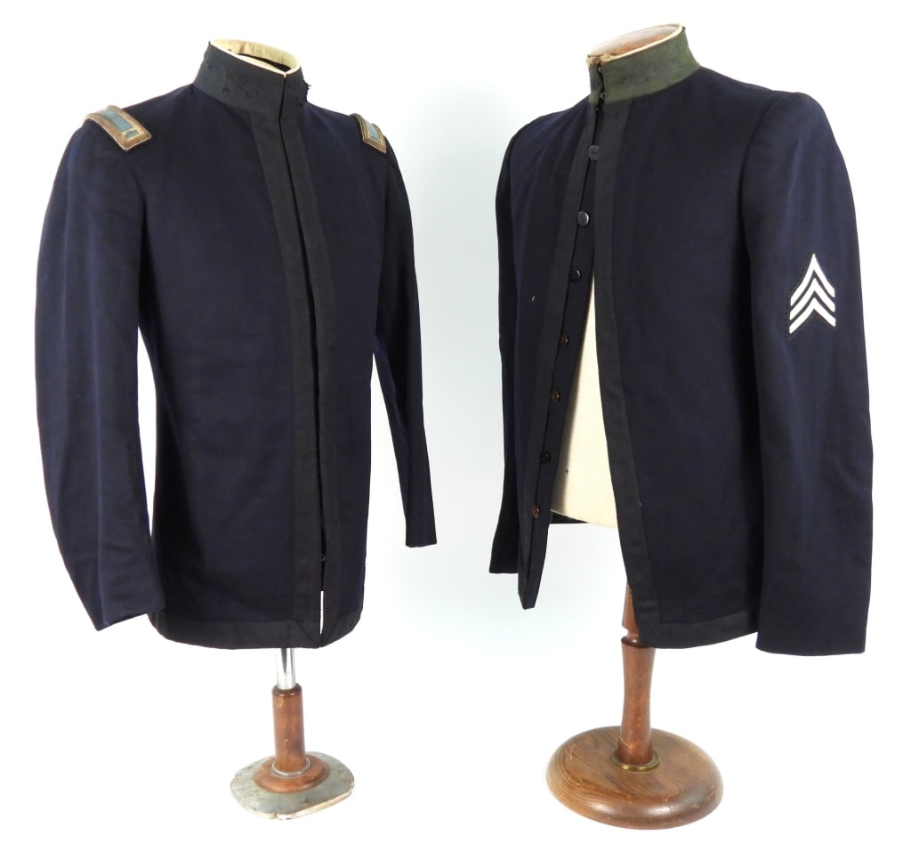 Two Richmond Light infantry Blues M-1895 Tunics: A Model 1895 tunic with a dark blue broadcloth body with black mohair tape on the fronts, base of the tunic, and the collar, white piping sewn to the top of the collar, 1st lieutenant's shoulder
