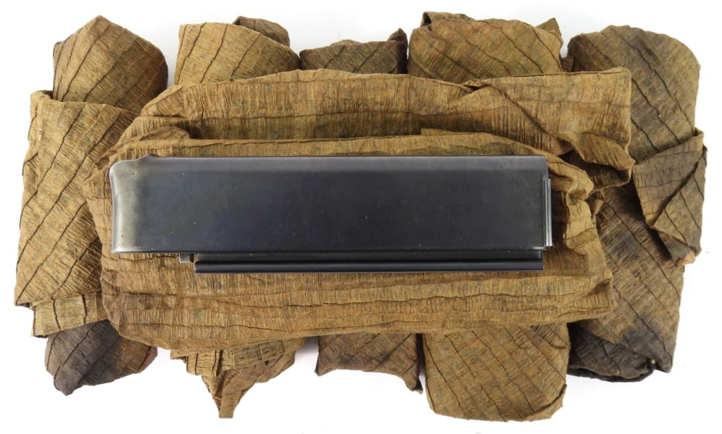 Six Patent Date Thompson SMG Magazines: Six patent date Thompson SMG magazines in a paper wrapping, one unwrapped in the crate is marked "PATENTED-AUG. 24, 1920/AUG 24, 1920.-JAN. 11, 1921".Disclaimer and lot information: Many states