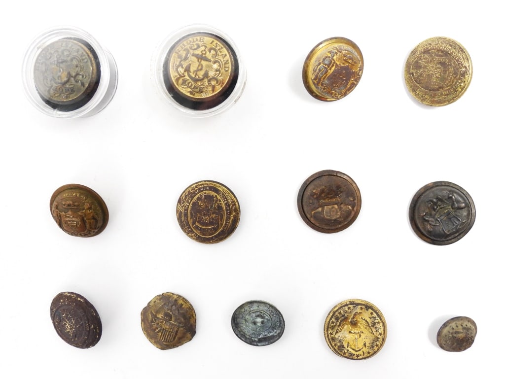 Group of Civil War-era State Buttons: A coat-size Rhode Island button in a plastic button case which is marked "EZRA/CHURCH" on the bottom, with an intact shank and "D. EVANS" back mark (22.8mm); a coat-size Rhode Island button in a