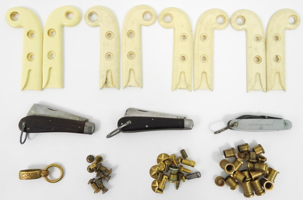 Group of USCG/USMC Knives and Sword Grip Parts: A U.S. Marine Corps folding pocket knife; a Kutmaster U.S.C.G. 1944-dated rope knife; a Camillus U.S.C.G. 1944-dated rope knife; eight U.S. Marine Corps plastic sword grips; and brass hilt screws,