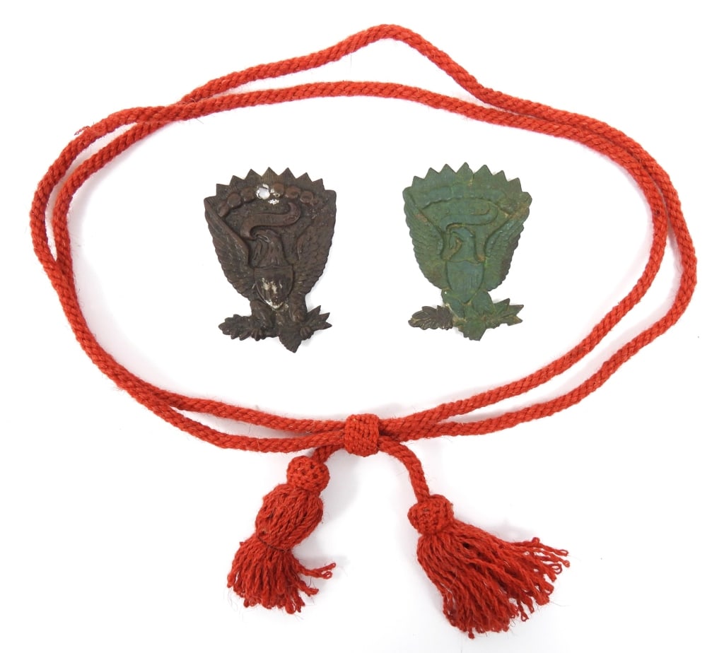 Civil War Hat Cord and Insignia: An original red woolen artillery hat cord; and two dug brass Model 1858 Hardee hat devices.