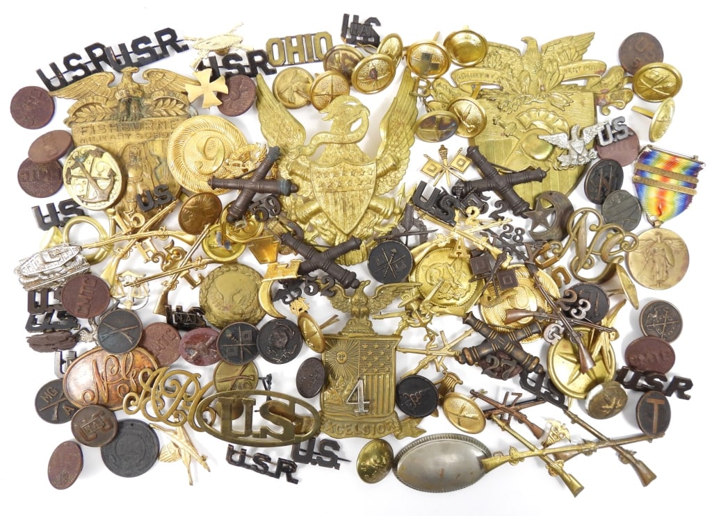 Group of Late 19th Century and WWI Insignia: Large group of cap and hat insignia; collar discs; crossed cannon and rifle insignia; and other miscellaneous insignia.