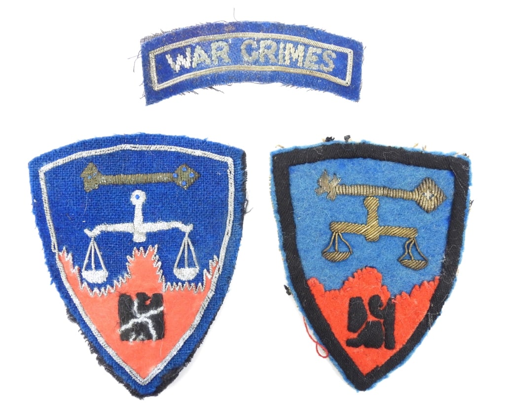 Two Post-WWII Nuremberg War Crimes Trail Patches: A shield of blue wool cloth with embroidered scale, and a coarse linen-like buckram backing; and a blue wool patch with embroidered insignia and "WAR CRIMES" tab.