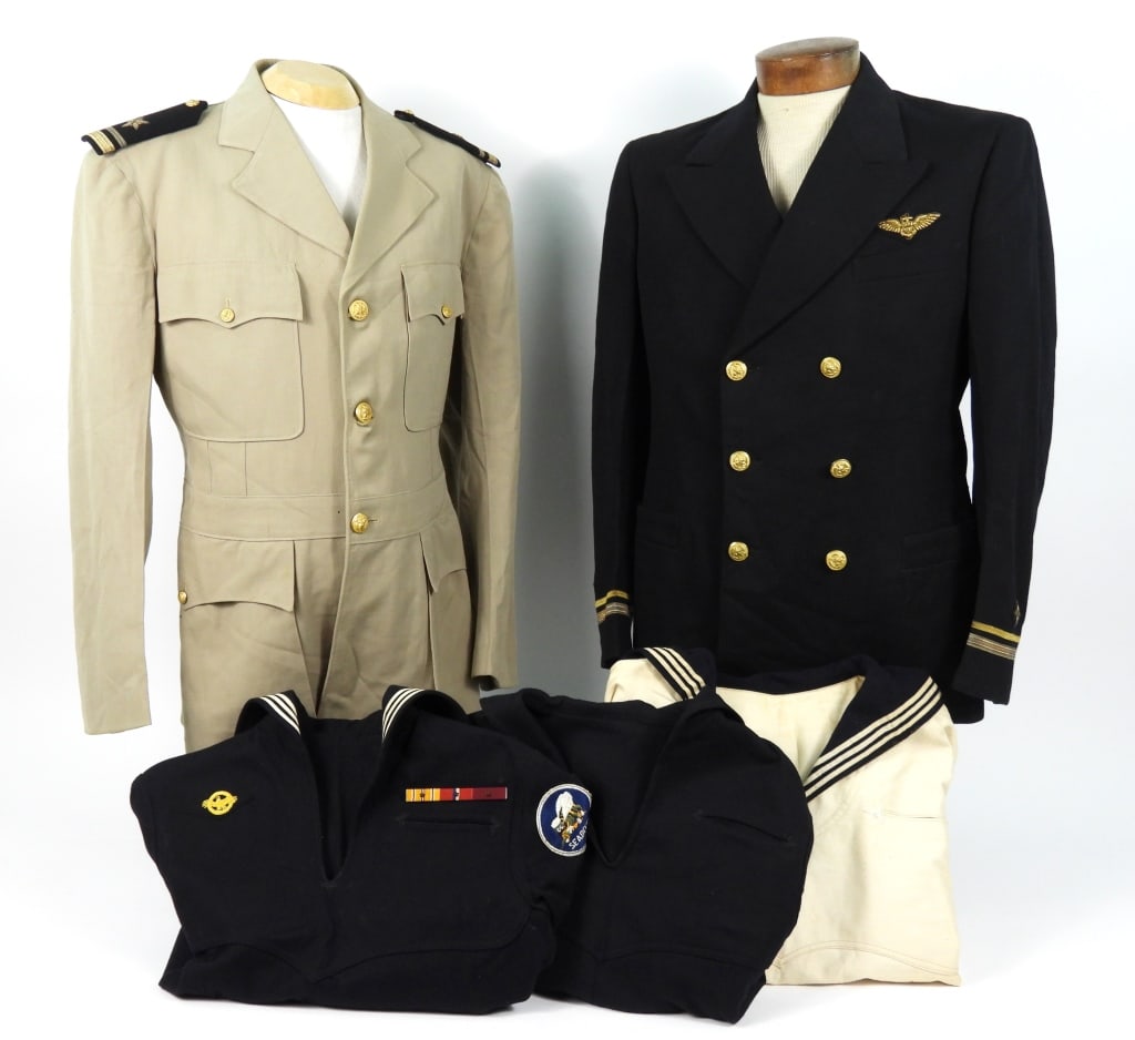 Group of US Navy Uniforms: Dark blue/black twill woven wool officer's coat with brass U.S. Navy buttons, embroidered naval aviator's wings above the left breast pocket, lieutenant junior grade insignia on the cuffs, black