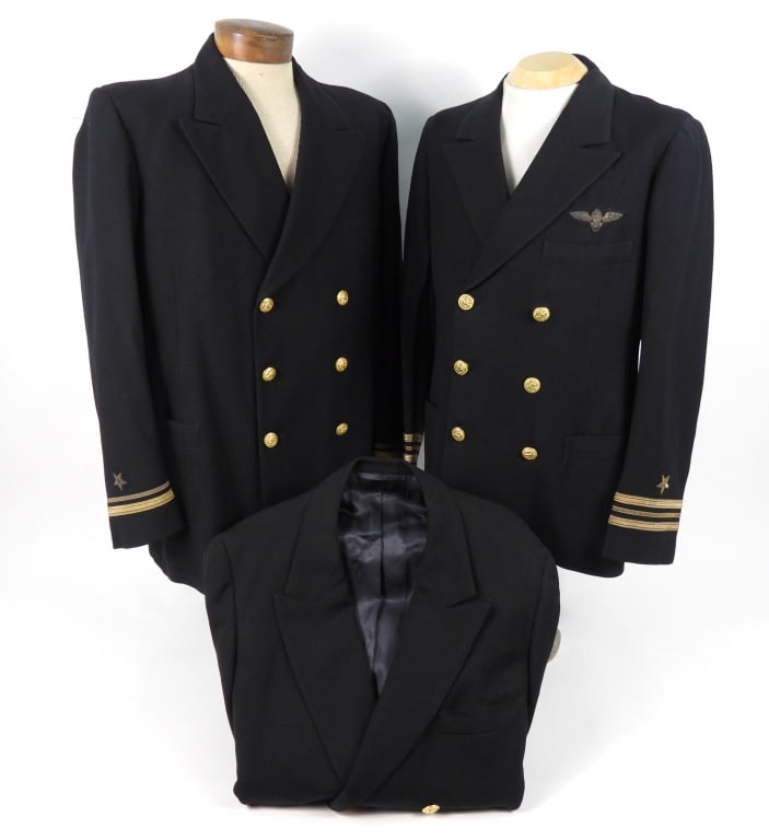 Three US Navy Dress Coats: A dark blue/black twilled woolen coat with brass U.S. Navy buttons, gold metallic lieutenant junior grade insignia on the cuffs, a black lining with a tag inside the pocket marked "ENOS. D. TOW"; a