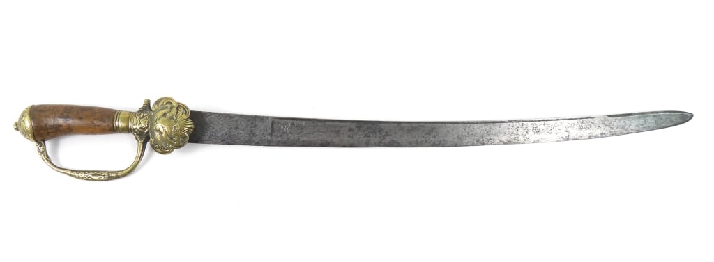 European Hunting Cuttoe: Cast-brass grip with classical themes and hunting scenes, burl wood grip, clamshell-type langet with wild animals, and a steel blade engraved on both sides with foliate designs. Europe Blade lg. 19
