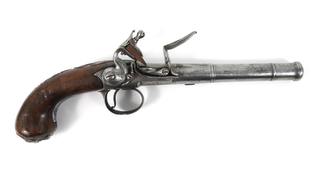 Richard Wilson Queen Anne-style Flintlock Pistol: .60-inch bore, NSN, walnut grip with raised clamshell carving around the barrel tang, silver grotesque mask butt plate, silver panoply of arms side plate, silver wrist plate, cock engraved with foliat