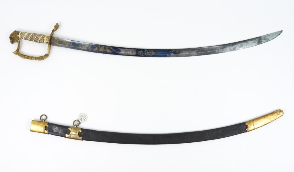 Eagle Pommel Sword and Scabbard: Gilt brass hilt with an eagle pommel, ornate knuckle bow with foliate designs, with a monster head quillon, bone grip carved with foliate designs, steel blade with patriotic motifs, foliate designs,