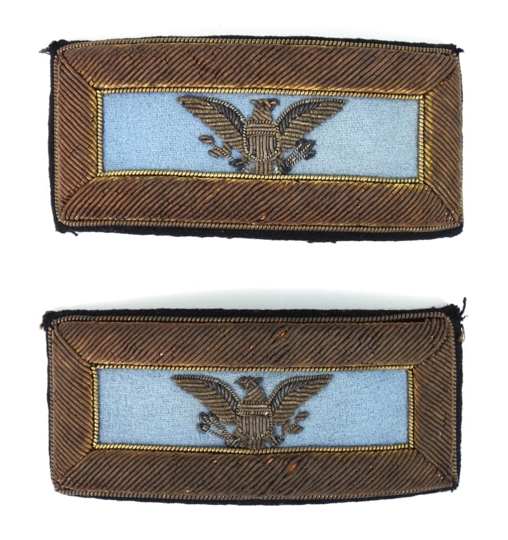 Civil War-era Infantry Colonel Shoulder Straps: Silver bullion embroidered eagles on a sky blue backing bordered in gold bullion, on a dark blue superfine backing, with a piece of dark blue superfine hand-sewn on the back. United States C. 1861-70