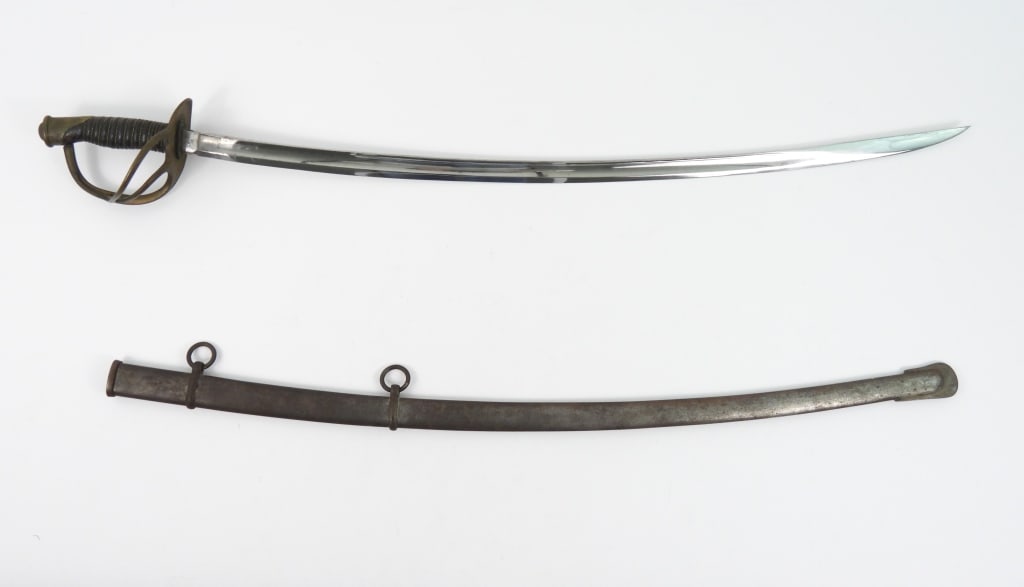 US Model 1860 Ames Light Cavalry Saber & Scabbard: Brass hilt, wire-wrapped leather grip, steel blade with light Ames marking on one side of the ricasso, and "US/J.F./1864" on the other, with a steel scabbard marked "G.K.C." on the drag. United States