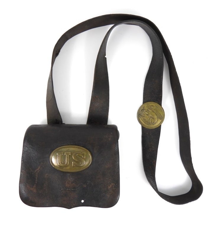 Civil War-era Cartridge Box, Strap, and Plates: Black leather cartridge box, brass lead-filled "US" plate on the flap, light makers mark on the inner flap, tins, a black strap with a lead-filled brass eagle plate on the breast. United States C. 186