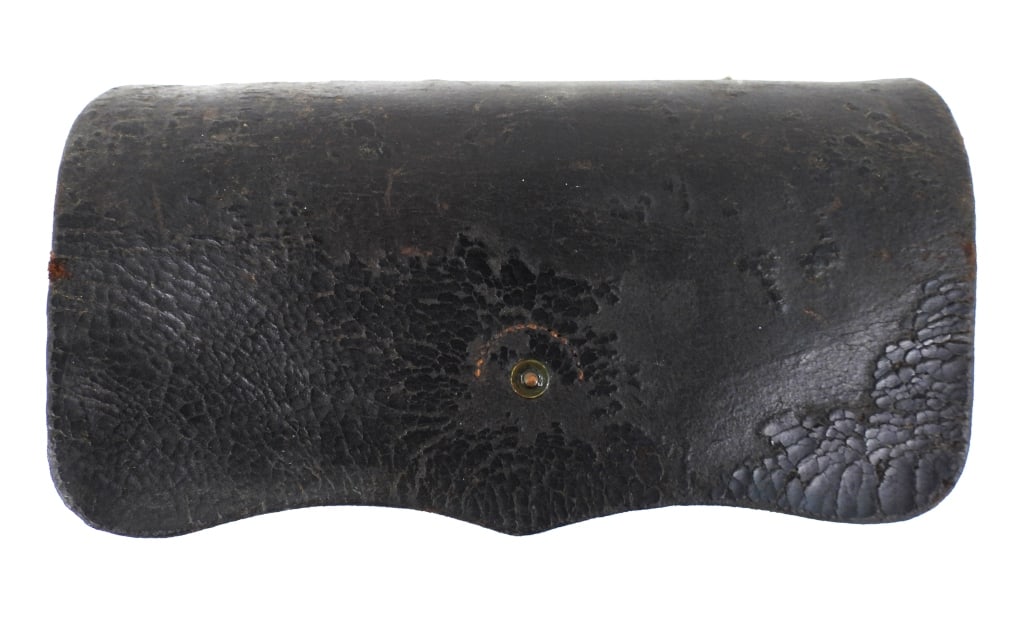 Civil War-era Burnside Cartridge Box: Black leather Burnside carbine cartridge box with the closure strap sewn and riveted, inner flap marked "DINGEE & LORIGAN/MAKERS/NEW-YORK", and a twenty-hole wooden block. United States Overall lg. 8 