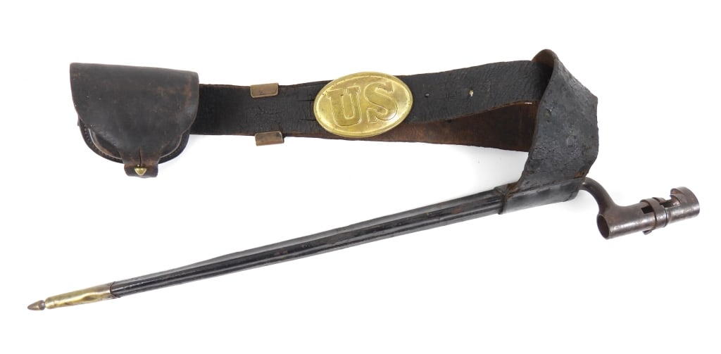 Civil War-era Belt, Bayonet, and Cap Box: Black leather belt with a brass keeper, and a lead-filled brass buckle marked "US", a black leather cap box marked "BAKER &/N.Y./McKENNEY", a black leather bayonet scabbard, and a Model 1855 bayonet m