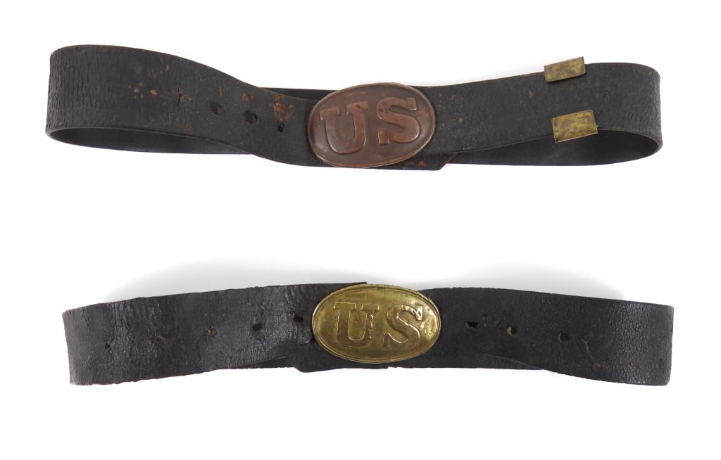 Two Civil War-era Belts and Buckles: A black leather with a brass keeper and a lead-filled brass belt plate marked "US" with "puppy paw" attachments, stamped W. H. SMITH BROOKLYN, with C.J.S. scratched into the lead; and a black leather