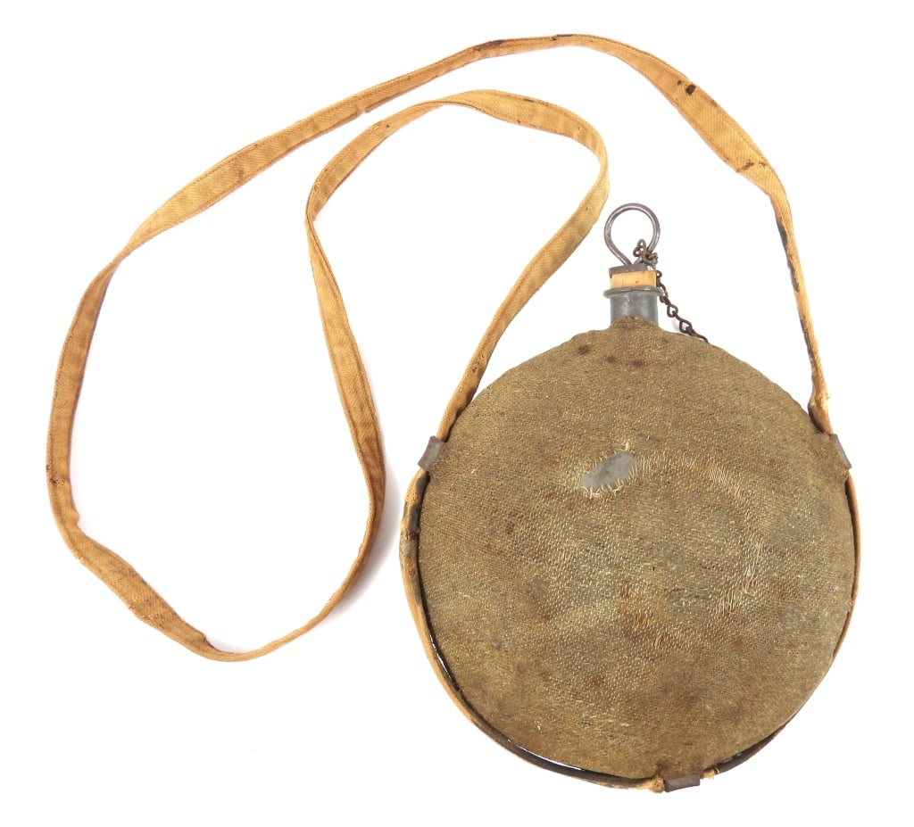 Civil War-era Cloth-covered "Smooth Side" Canteen: Model 1858 "smooth side" canteen with a jean cloth cover, stopper and chain, and a sewn herringbone twill strap. United States Overall ht. 10 1/2"