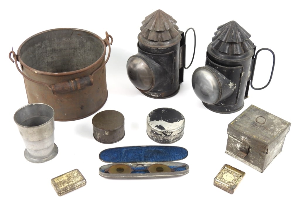 Group of Civil war-era Tin Items: Two cap tins; a small tinned iron cook pot with an iron bale and wooden handle; a rectangular tinned iron box; a collapsible cup; a pair of spectacles in a tinned iron case; two match safes; and two