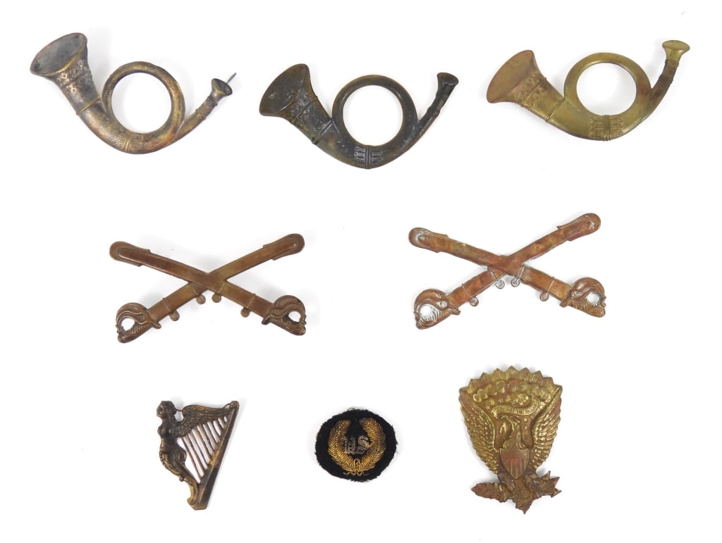 Civil War-era Cap/Hat Insignia: Two infantry bugles with wire loops on the back; an infantry bugle with wires on the back; crossed sabers with wire loops on the back; crossed sabers with one wire on the back; a Hardee hat eagle