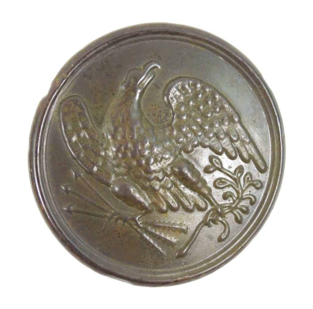 Civil War Union Breast Plate: Lead-filled bras plate with an eagle clutching arrows and an olive branch, with iron wire loops on the back for attaching to a cartridge box or sword belt strap. United States Dia. 1 3/8"