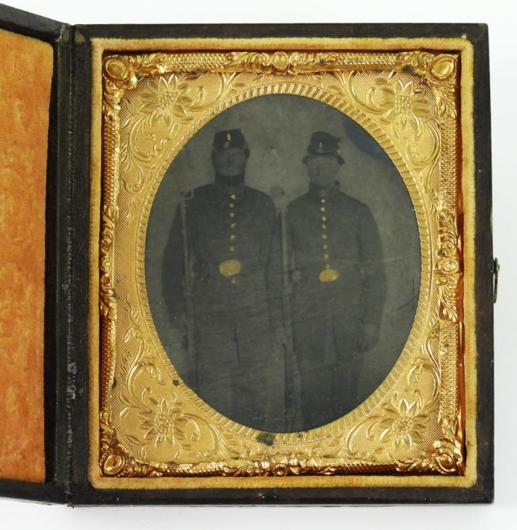 Tintype of Two Armed Civil War Soldiers: Image of two soldiers wearing Model 1858 frock coats, forage caps, belts with "US" belt plates, armed with muskets and bayonets, with a note written in pen behind the image with a vague description