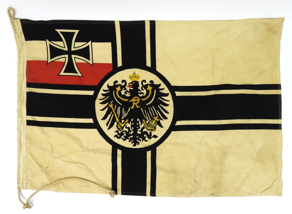 Imperial German WWI Flag: White plain woven material with a central eagle, red, white, and black stripes and an Iron Cross in the canton, and a white twill woven hoist with very light ink stamped markings. Germany 23" x 35"
