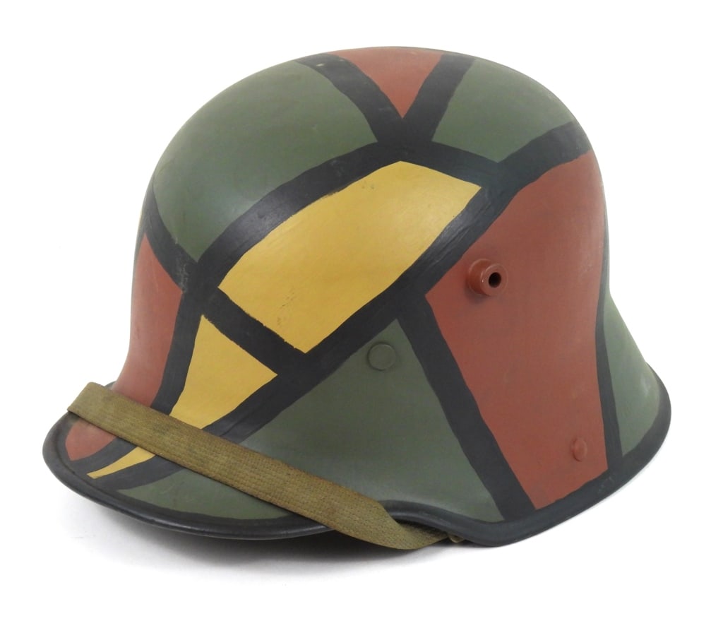 Repainted WW! German Model 1916 Helmet: Repainted helmet with camouflage patterns, cloth chinstrap, marked inside the shell "Si 66", with a Prairie Flower Leather Company replacement liner. Germany