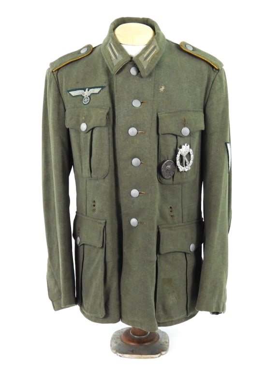 WWII German Model 40 Army Tunic: Field gray wool broadcloth tunic with a green-back breast eagle, cavalry/armored reconnaissance shoulder straps, collar litzen, a wound and infantry assault badge on the left pocket, green-backed