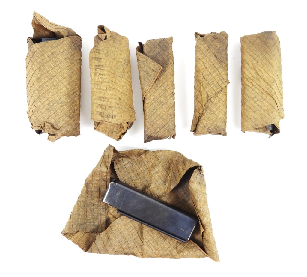Six Patent Date Thompson SMG Shot Magazines: Six patent date Thompson SMG magazines in a paper wrapping marked "PATENTED-AUG. 24, 1920/FOR 18 SHOT CARTRIDGES/AUG 24, 1920.-JAN.- 11- 1921". United States Overall lg. 6 1/4" Disclaimer and lot info