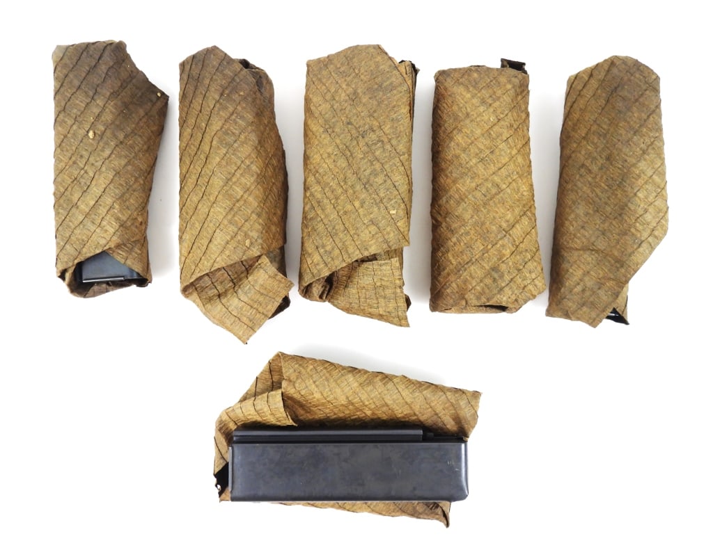 Six Patent Date Thompson SMG Shot Magazines: Six patent date Thompson SMG magazines in a paper wrapping marked "PATENTED-AUG. 24, 1920/FOR 18 SHOT CARTRIDGES/AUG 24, 1920.-JAN.- 11- 1921". United States Overall lg. 6 1/4" Disclaimer and lot