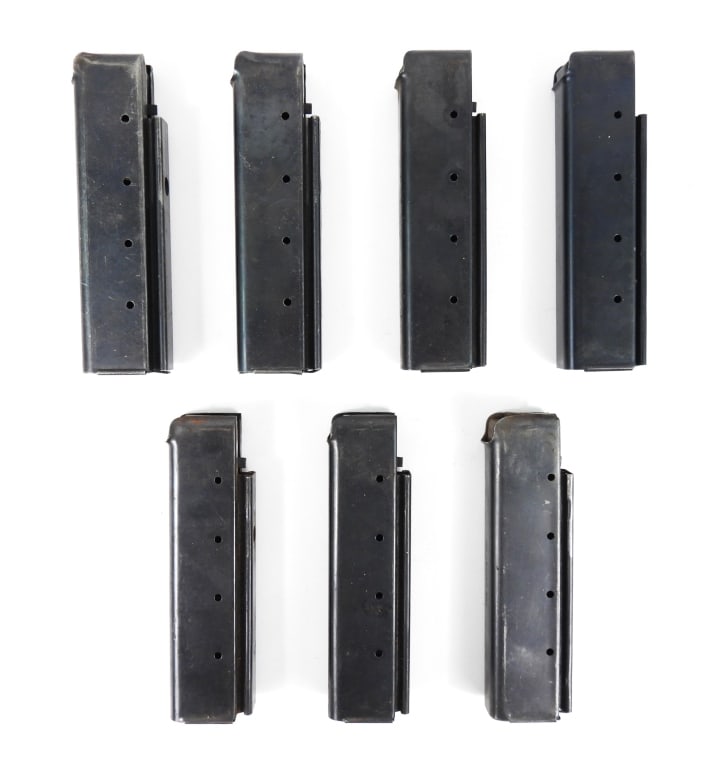 Seven Thompson SMG Magazines: One magazine marked "THE CROSBY CO."; four magazines marked "W.P.S.", and two unmarked magazines. United States Overall lg. 6 1/4" Disclaimer and lot information: Many states restrict or prohibit
