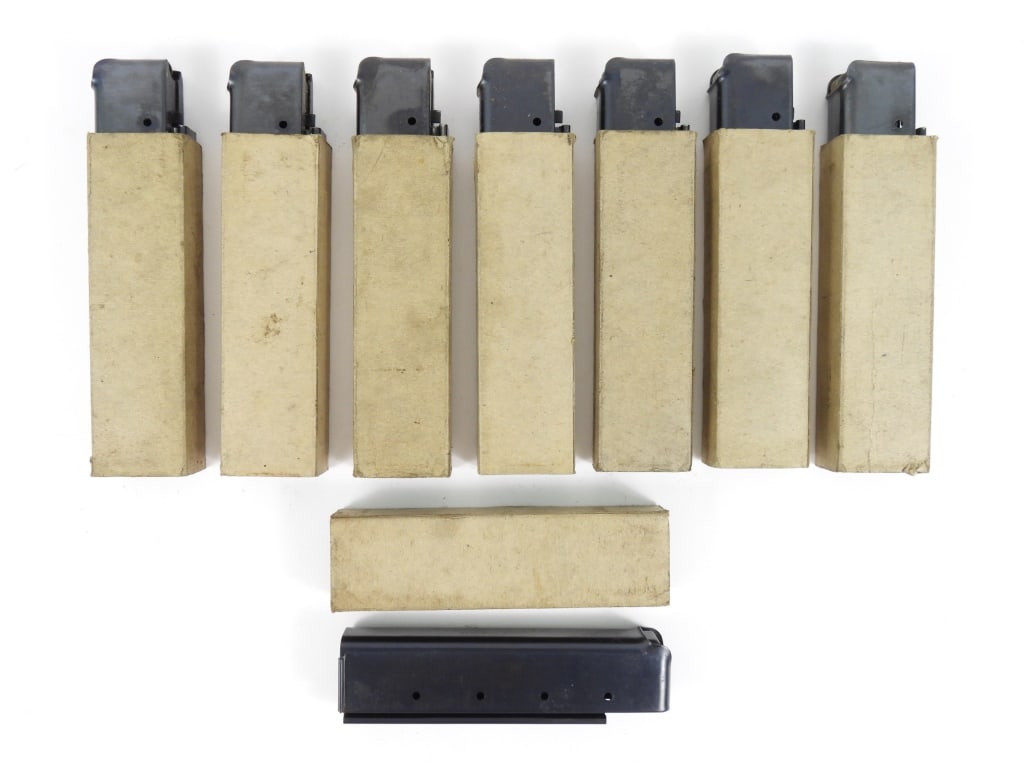 Eight Seymour Products Thompson SMG Magazines: Eight Thompson SMG 20 round magazines in pasteboard sleeves, all marked "THE SEYMOUR PRODUCTS CO/SEYMOUR, CONN". United States Overall lg. 6 1/4" Disclaimer and lot information: Many states restrict