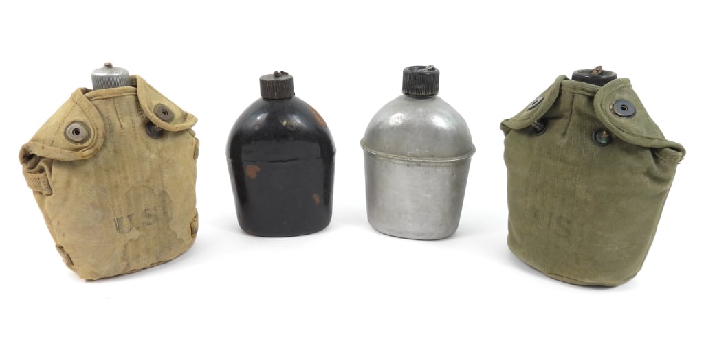 Group of US Canteens: A black enameled canteen marked "U.S./U.S.S. CO./1942" on the bottom; a WWI-era canteen in a cavalry canvas cover; an OD#7 canteen cover dated 1945; a canteen marked "U.S./S.M. CO./1943; and a canteen