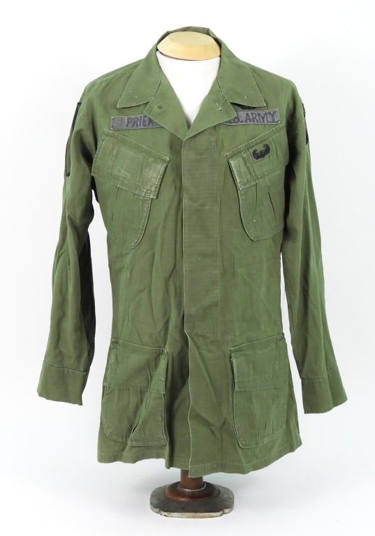Vietnam 101st Airborne/1st Cav 3rd Model Jacket: OD rip-stop OG-107 cotton coat with a 1st Cavalry patch on the right sleeve, marked "PRIER" above the right pocket flap, Air Assault qualification patch sewn on the left pocket flap, Flight Wing patch