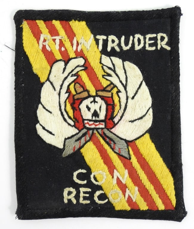 Vietnam R.T. Intruder Con Recon Patch: Hand embroidered patch with a black background and border, with wings, a skull, and crossed swords, marked "R.T. INTRUDER/CON/RECON". Vietnam Overall ht. 3 5/8" Overall wd. 2 7/8"