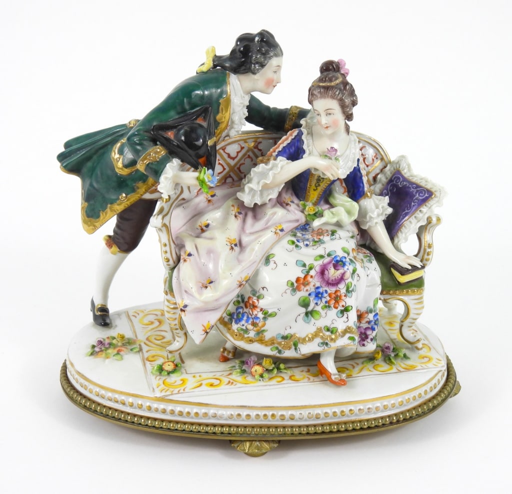 19C Porcelain Courting Couple Figurine: A highly detailed, hand painted, quality Dresden-style porcelain figurine. Stamped "Germany" on the affixed brass base. No other marks observed.8"w x 6"d x 8" h