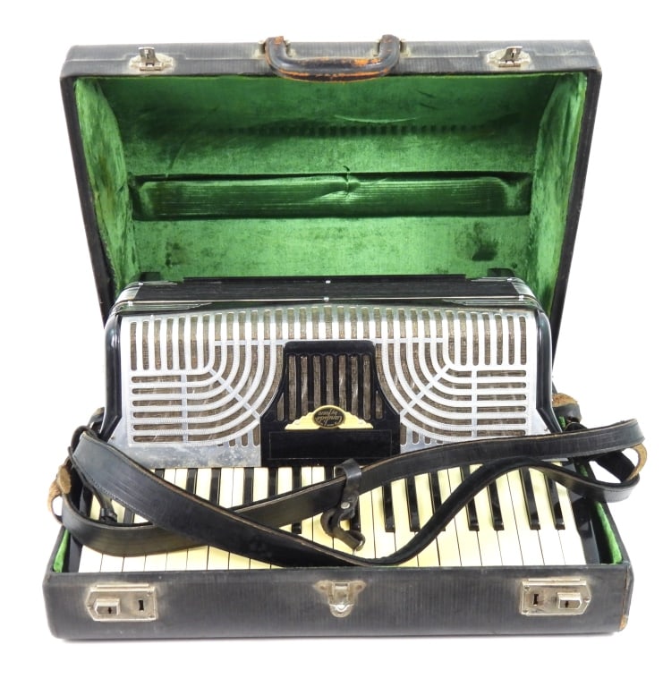 Candido Lorio Accordion With Case: Appears to be 1940s or 1950s era in the Art Deco design. Standard size with 41 keys and 120 bass chord buttons. Black body with black bottom felt. Includes straps and original carrying case. Bellows
