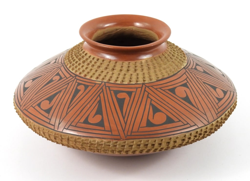 Mata Ortiz Signed Pot: Mata Ortiz clay pot with traditional Native American symmetrical and textured designs, signed on bottom by Lucie Soto. Approx. 12 1/2" wide x 6 1/2" high.