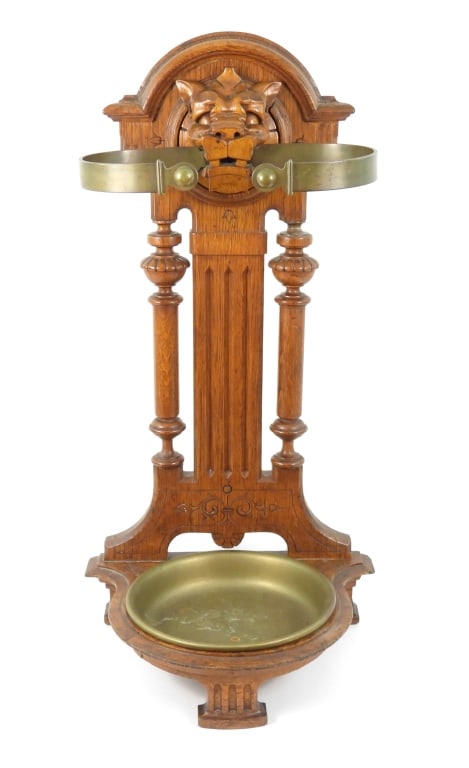 Eastlake Victorian Style Oak Umbrella Stand: An interesting oak umbrella and cane stand in the Eastlake - Victorian style. Oak base with 3 carved feet supporting a removable round brass basin for catching water. The main structure is of oak with
