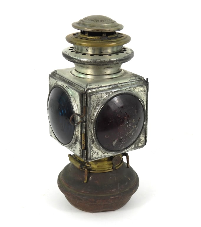 Antique Indiana Lamp Co. Lantern: Automotive or Rail Road style with Blue, Red, and clear bullseye lenses and a heavily worn tinned finish. Marked as a Number 2 on top of vent. Measures 11.5" high x 5.5" wide. Lamp base does not lock