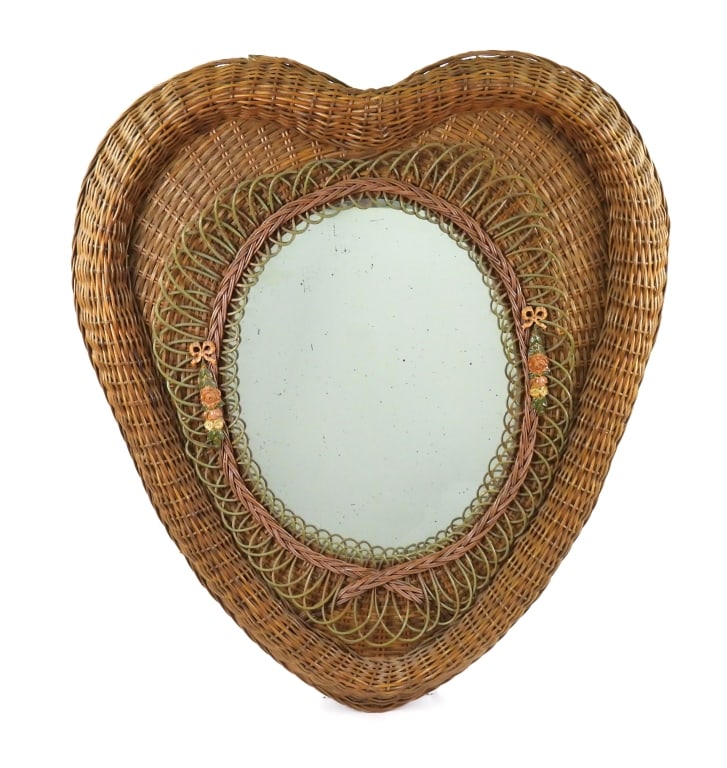 Large Wicker Heart Shaped Mirror: Impressive form mirror with ribbon decor affixed to the sides and single strand wicker bow on edge of glass. Thick heavy glass. Appears to be early 20th century with replaced backboard. Measures 31"