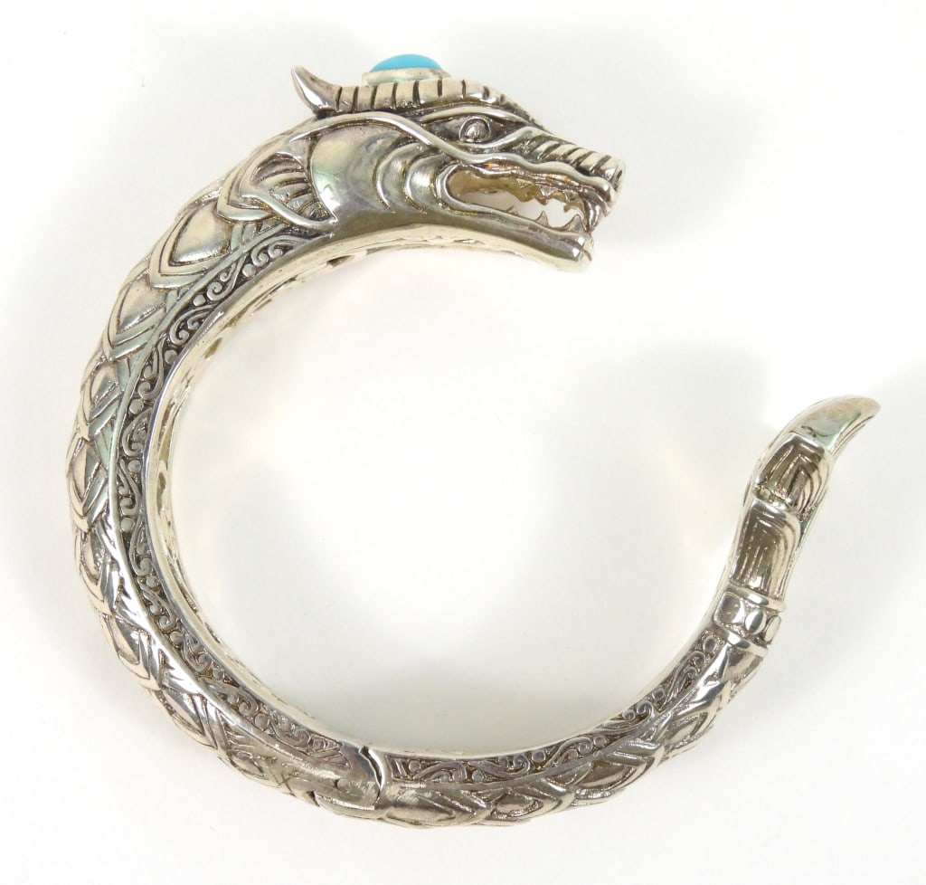 Heavy Sterling Hand Made Dragon Bracelet: Stamped "925" at tail. Quality made with hinged center spring. Has a sleeping beauty type Turquoise stone set in sterling silver and weighs approx. 3.50 ozt. overall.