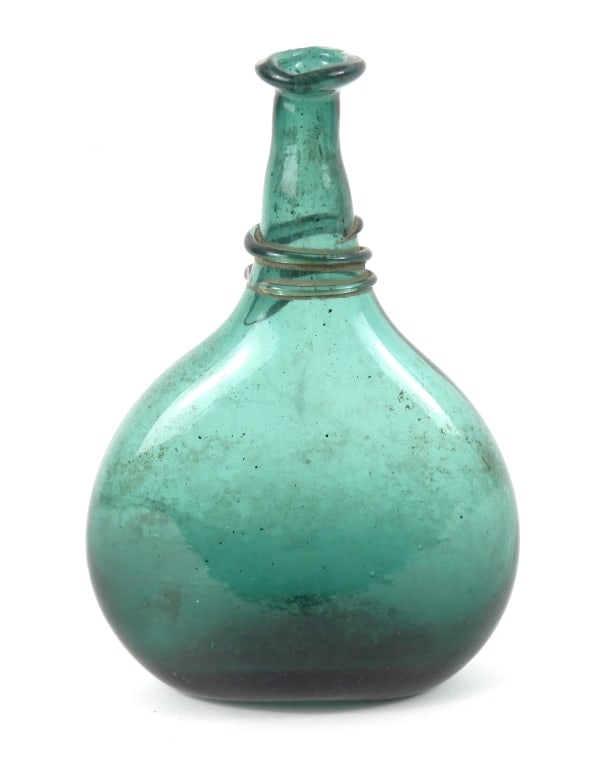 Early Middle Eastern Saddle Flask Bottle: Dark aqua color hand blown thick glass flask with neck twist spiral with high kick broken pontil base. Measures 6"w x 3"d x 9-1/2" high.