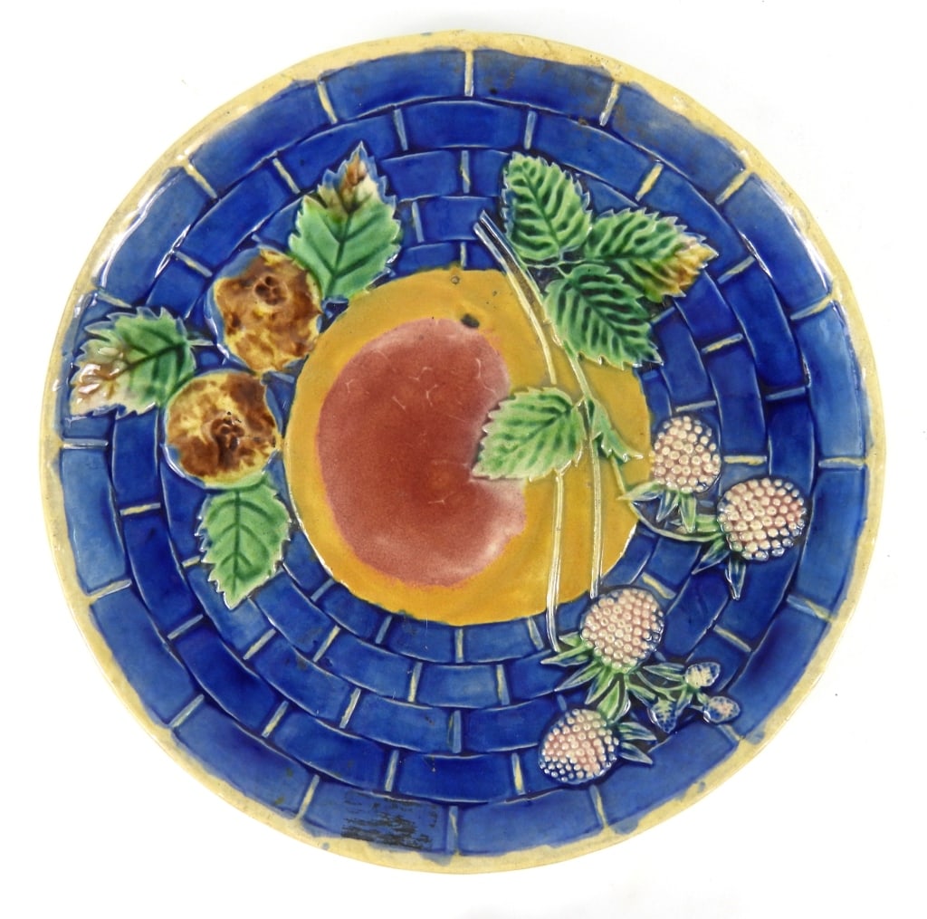19th-C Majolica Fruit Pattern Plate: Etruscan style with apple and strawberry design on a cobalt background. Measures 9-1/2" diameter. May be artist signed on rear with initials.