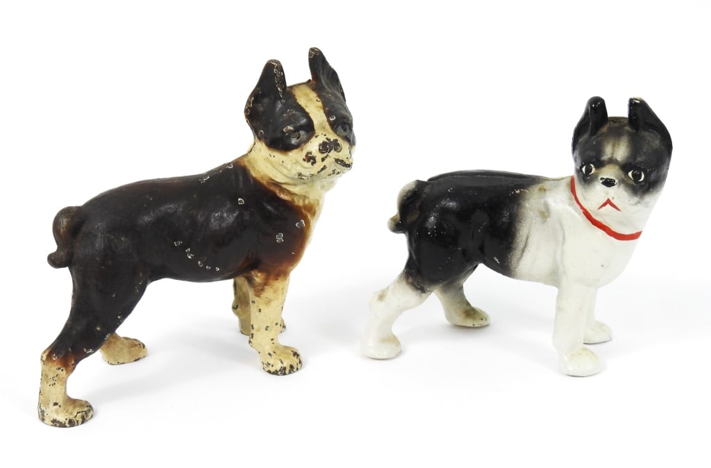 Two Cast Iron Boston Terrier Dogs: A small antique Bank that measures 5-1/2" long x 5" high. Has paint loss in areas consistant with age. Included is a small contemporary cast iron Terrier Bulldog that measures 5" long x 4-1/2" high.