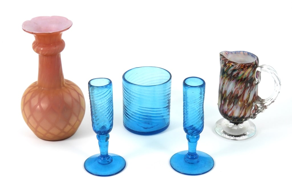 Grouping Of Blown Glass Items: 3 small ice blue twisted glasses tall ones measure 4-1/2" high. A polished pontil single handle pitcher that measures 4-1/4" high. A pink translucent diamond pattern vase with sharp pontil scar that m