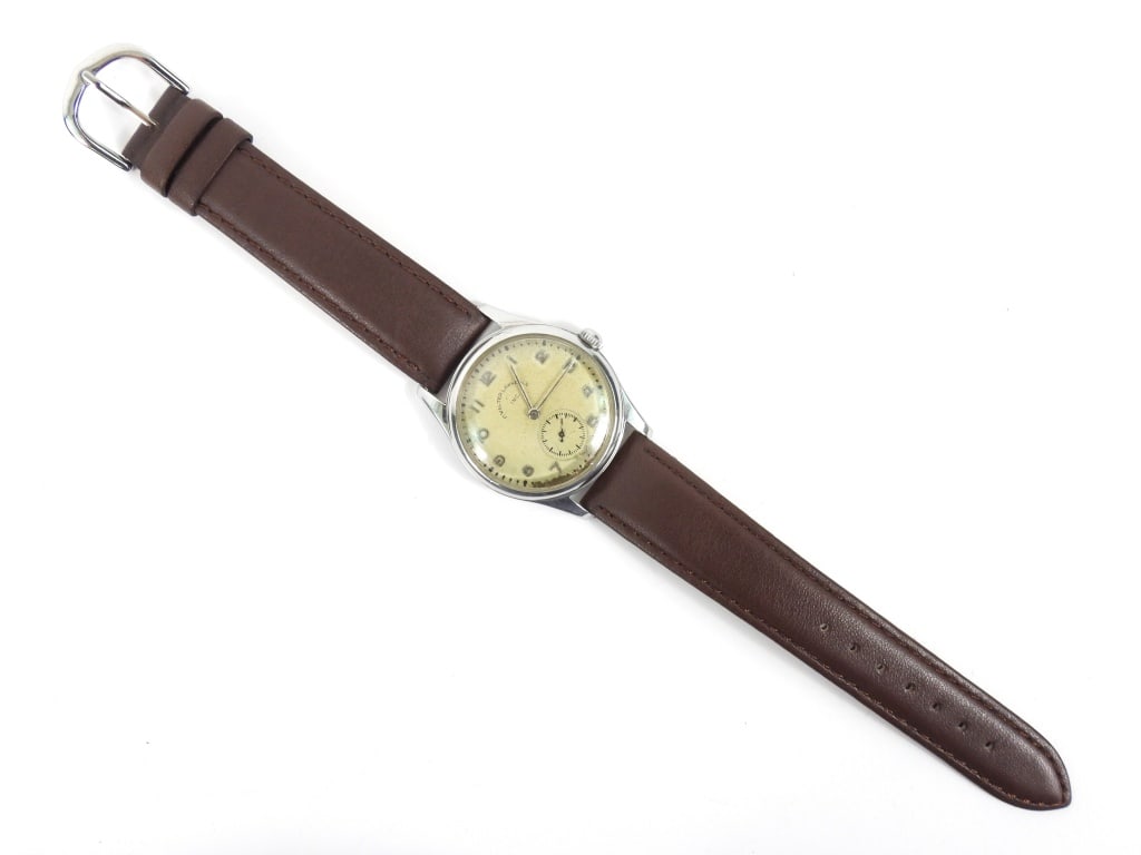 Antique Frank Walter Lawrence Wrist Watch: Early 20th Century. White dial marked "F. Walter Lawrence Inc." with silver colored Arabic numerals featuring a secondary dial with blued hands cased in white metal with brown leather strap. Case